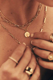 Handcrafted 14k gold personalized engraved pendant pictured on neck with necklace